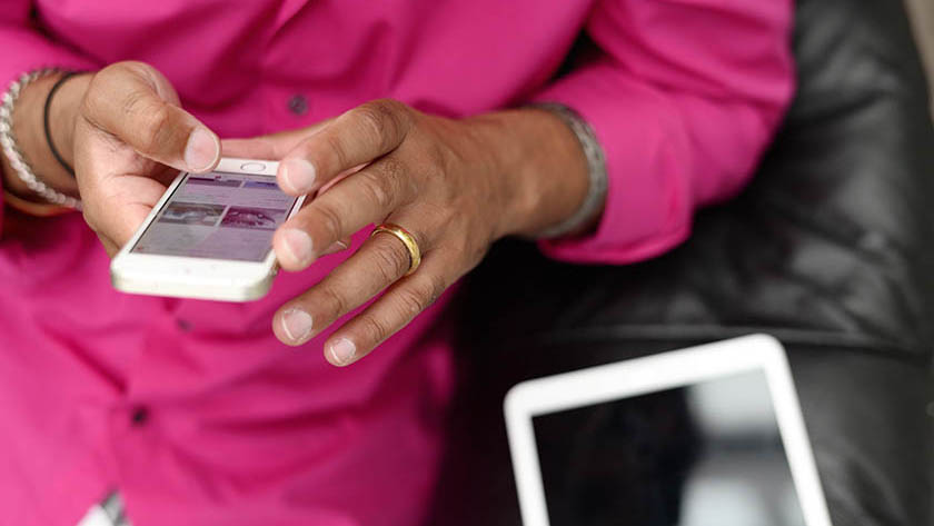 Image of a man holding a smartphone